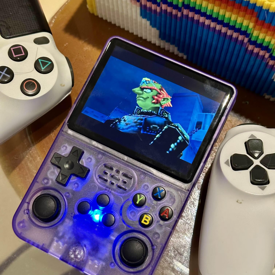 Handheld next to PlayStation cases